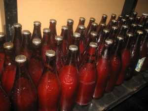 Old beer bottles full of tomato sauce